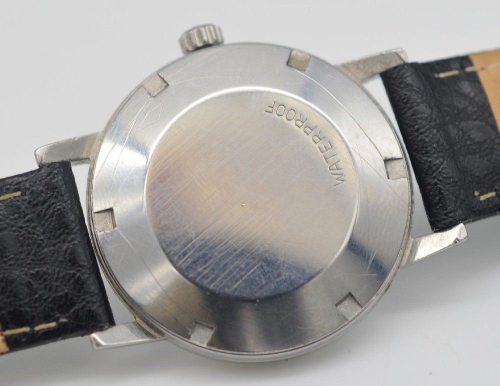 A vintage 1968 Omega Geneve automatic wristwatch featuring a deep navy blue dial, silver baton indices, stainless steel case, and black leather strap. View IV