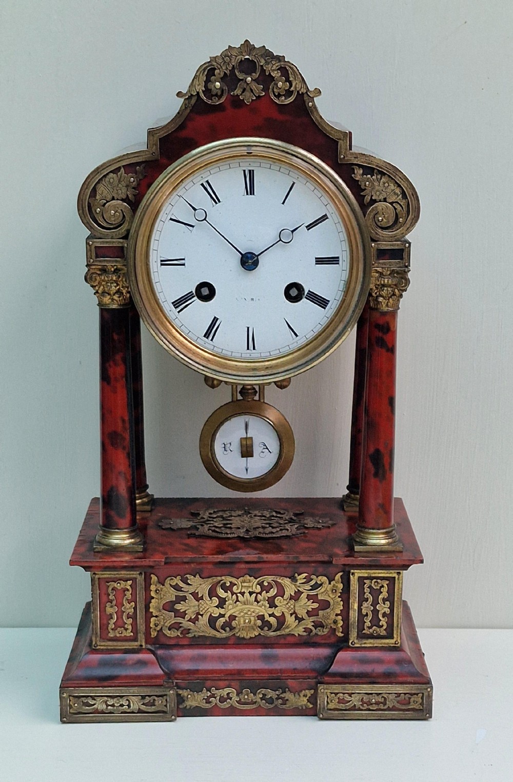 A Red Tortoishell Portico Clock
