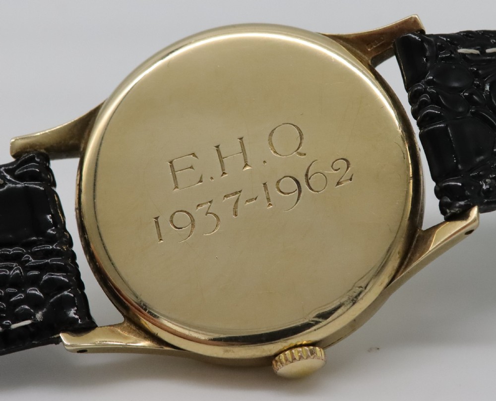 A vintage 1962 Longines wristwatch featuring a circular 9K gold case, cream dial with gold hour markers, sub-seconds dial, and a black leather strap. View V