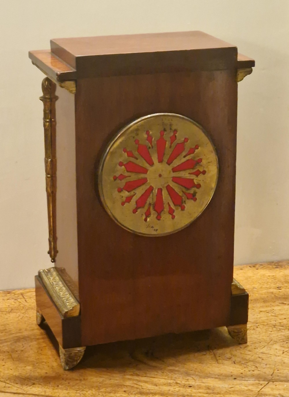 French Empire style mahogany mantel clock featuring gilt-brass floral garlands, fluted corner columns, and a white enamel dial with Roman numerals. View II