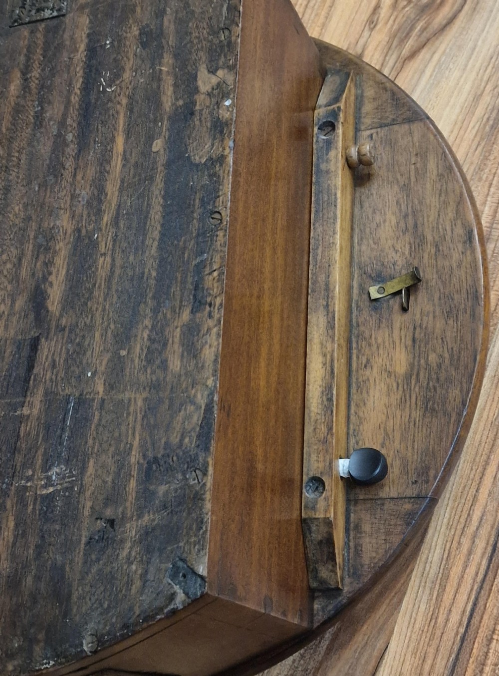 A circular mahogany wall clock featuring a brass bezel around an off-white dial with black Roman numerals and an RAF insignia. View II