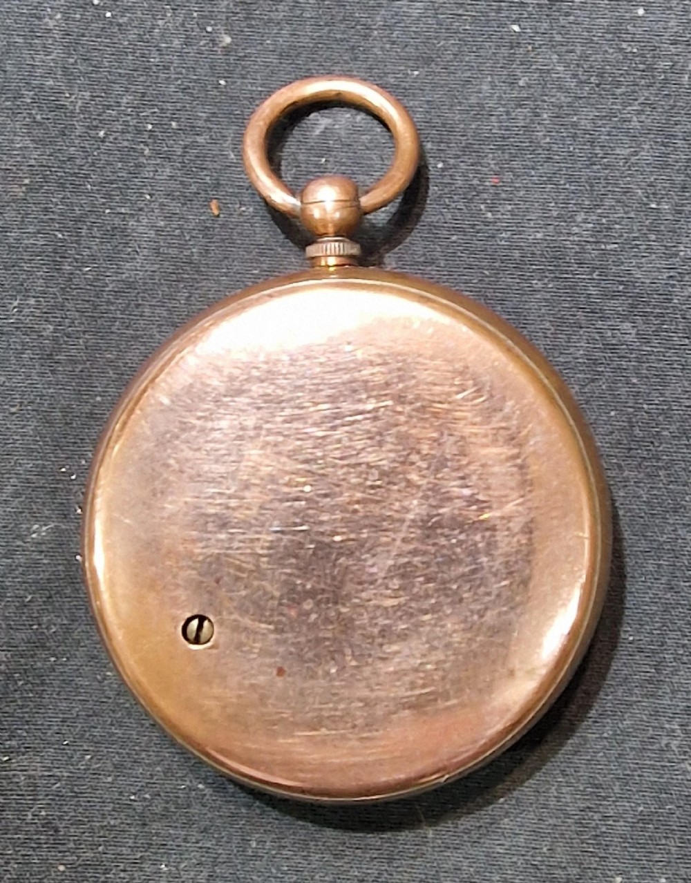 An antique pocket barometer by Aitchison London with a brass casing, silvered dial, and blued steel pointer. View II