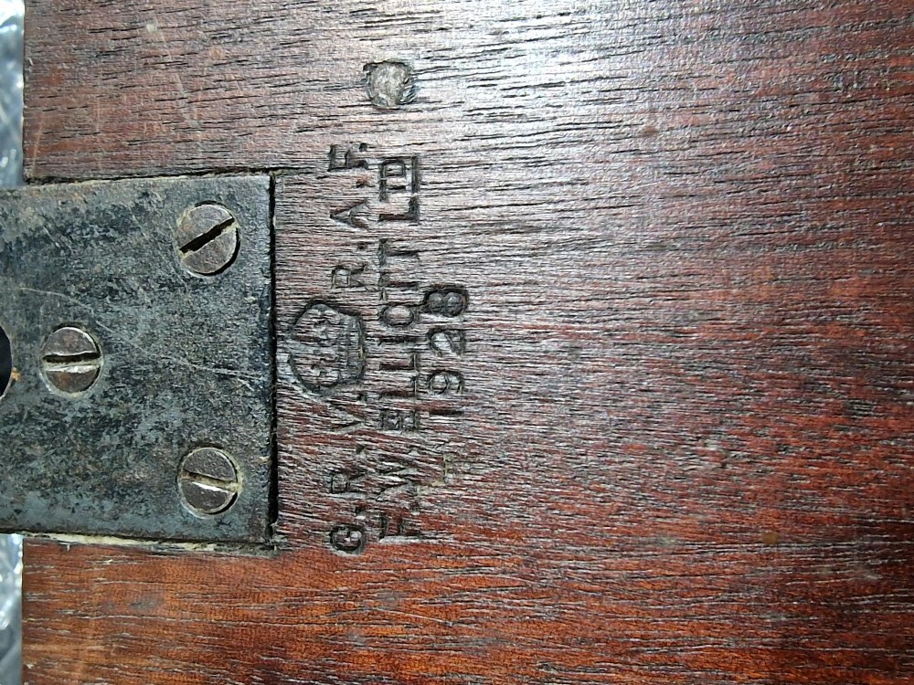 A circular mahogany wall clock with a brass bezel, white painted dial displaying black Roman numerals, and a royal cypher under the twelve oclock position. View VIII