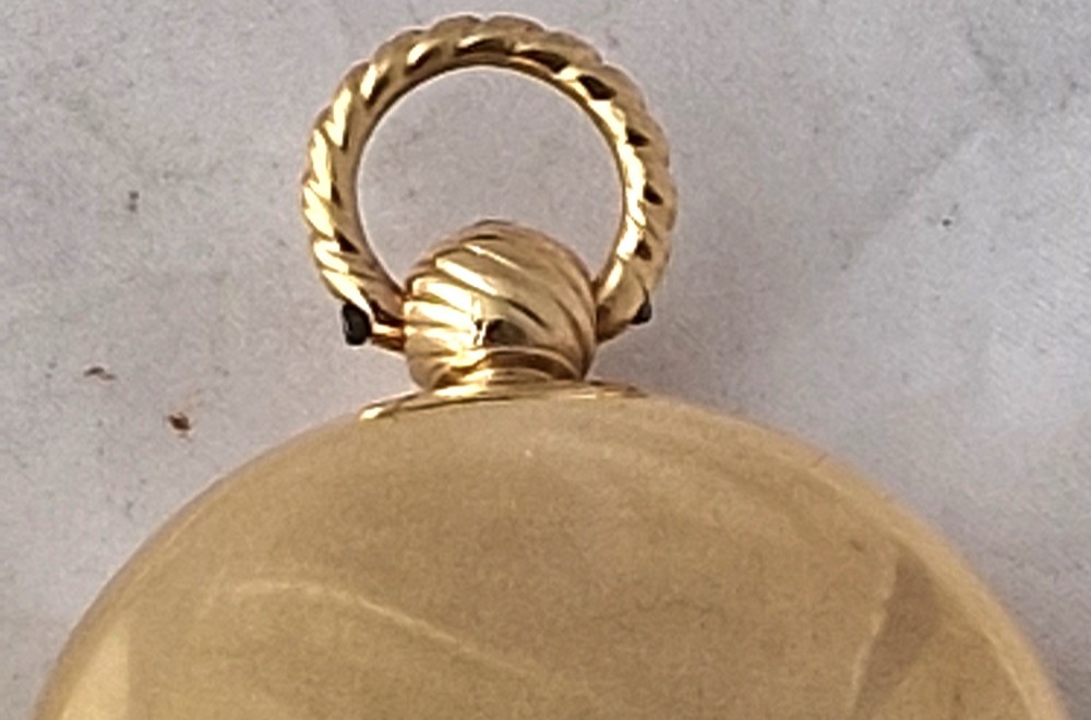 A Georgian gilt verge fusee pocket watch featuring a white enamel dial with Roman numerals and a textured twisted suspension loop. View II