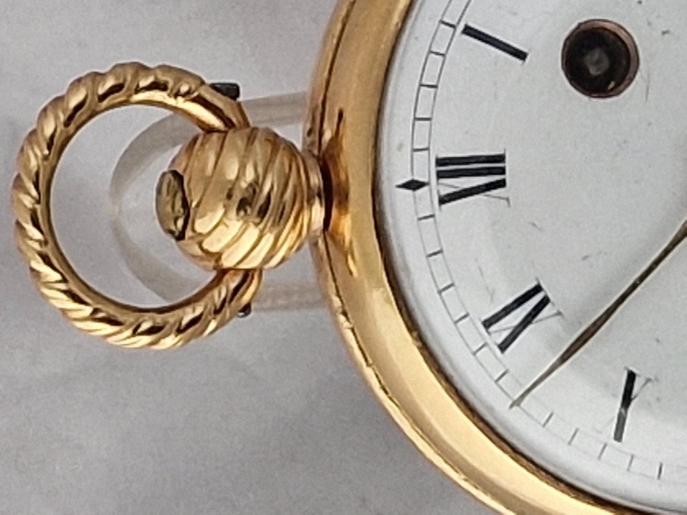 A Georgian gilt verge fusee pocket watch featuring a white enamel dial with Roman numerals and a textured twisted suspension loop. View III