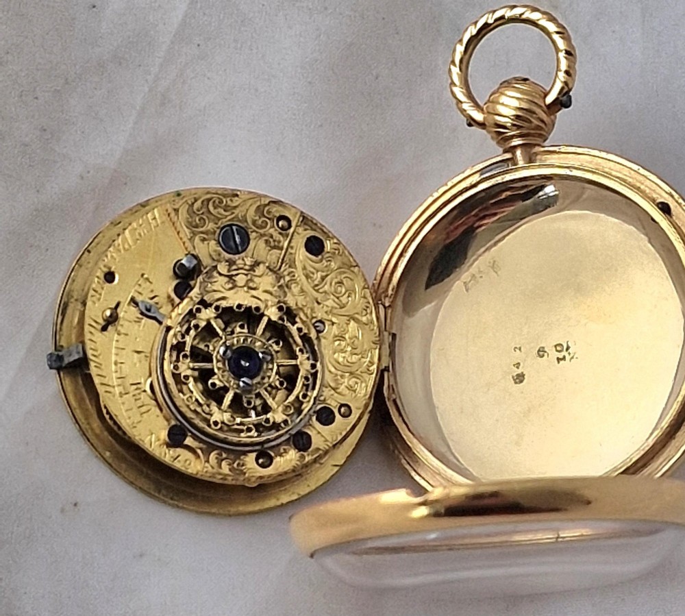 A Georgian gilt verge fusee pocket watch featuring a white enamel dial with Roman numerals and a textured twisted suspension loop. View IV