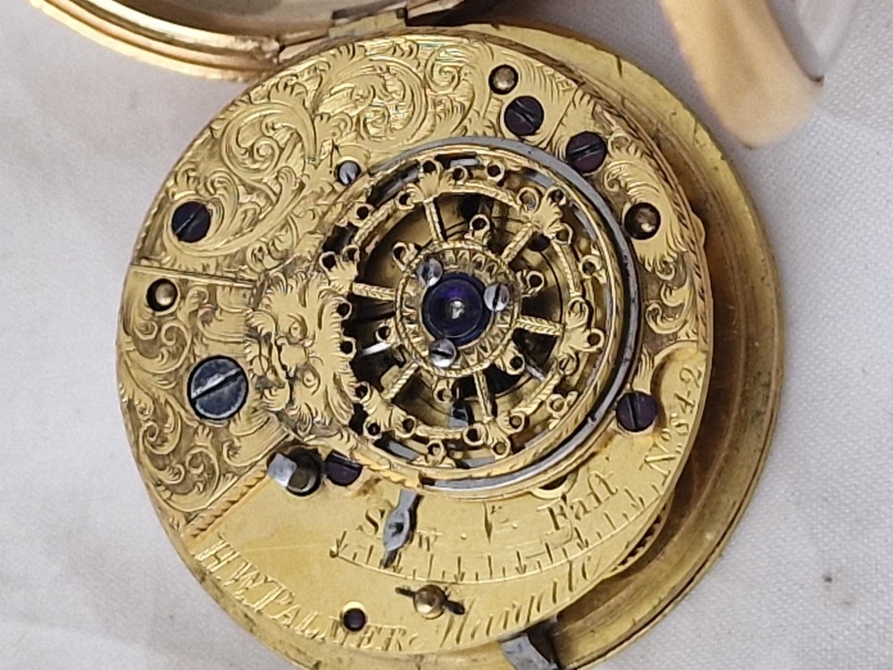 A Georgian gilt verge fusee pocket watch featuring a white enamel dial with Roman numerals and a textured twisted suspension loop. View V
