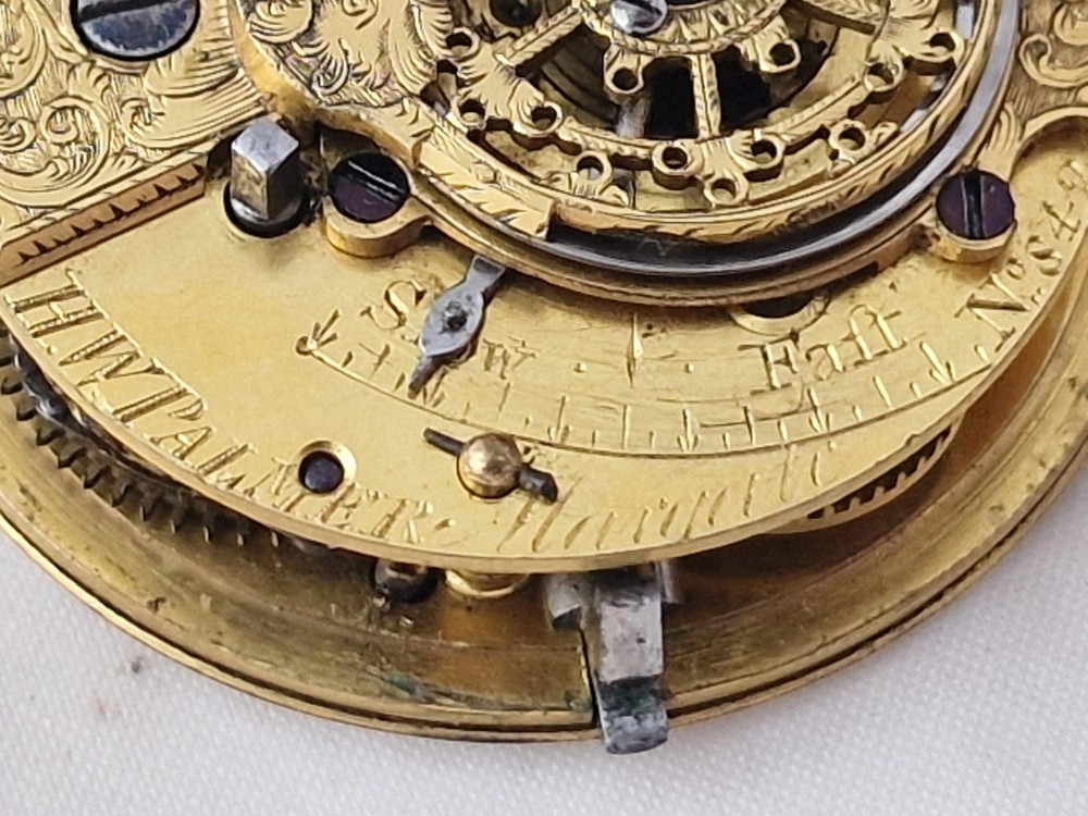 A Georgian gilt verge fusee pocket watch featuring a white enamel dial with Roman numerals and a textured twisted suspension loop. View VI