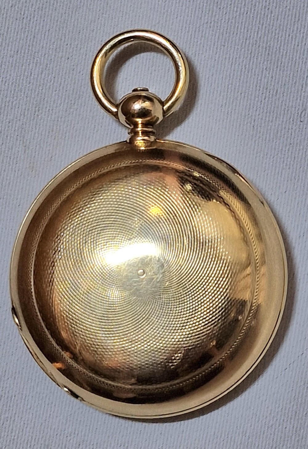 A 14k yellow gold full hunter pocket watch displayed with its cover open to show a white enamel dial with black Roman numerals and a subsidiary seconds sub-dial. View II