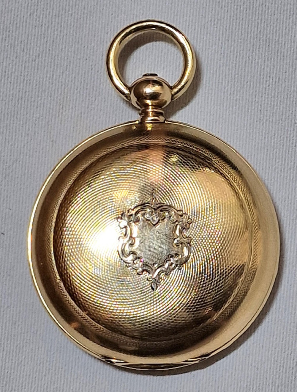 A 14k yellow gold full hunter pocket watch displayed with its cover open to show a white enamel dial with black Roman numerals and a subsidiary seconds sub-dial. View III