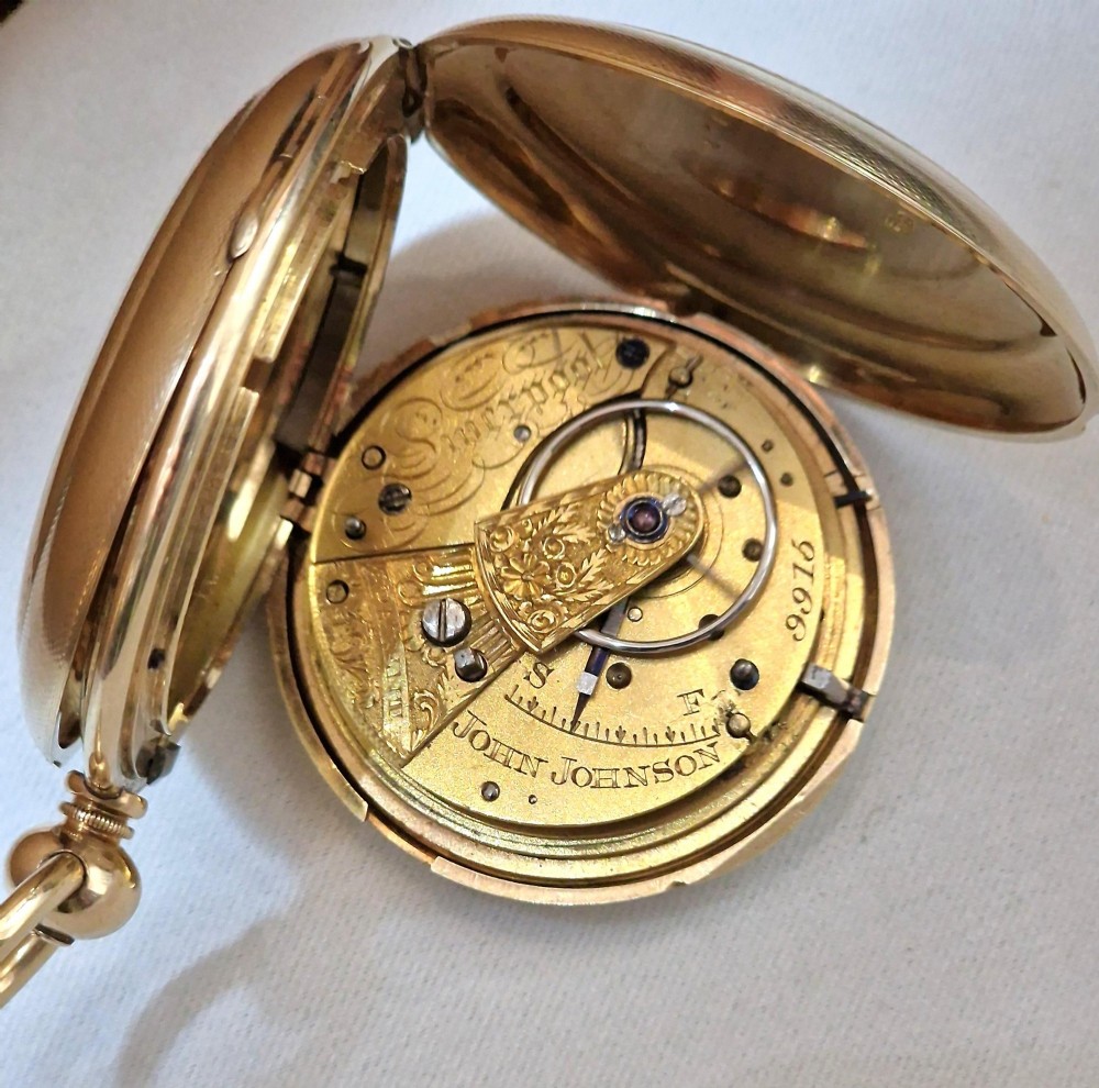 A 14k yellow gold full hunter pocket watch displayed with its cover open to show a white enamel dial with black Roman numerals and a subsidiary seconds sub-dial. View V