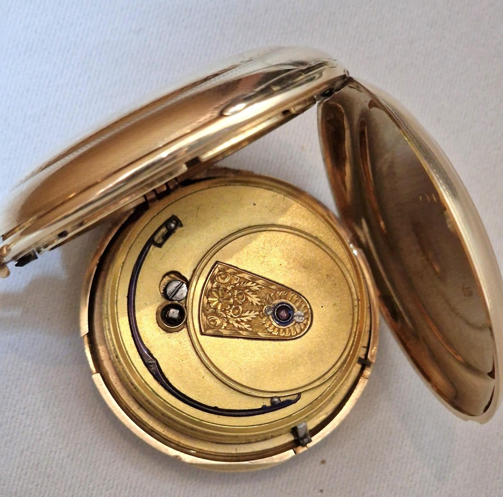 A 14k yellow gold full hunter pocket watch displayed with its cover open to show a white enamel dial with black Roman numerals and a subsidiary seconds sub-dial. View VII