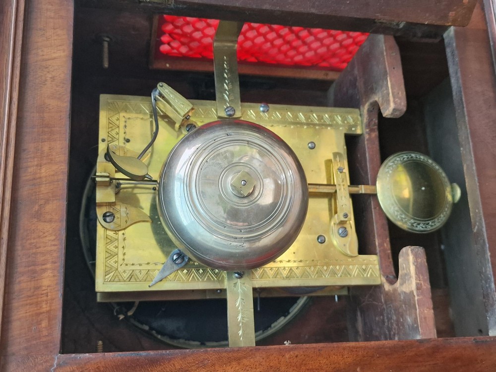 A Regency mahogany bracket clock featuring a white circular dial signed Thomas Jackson London, framed by brass stringing, lion head side handles, and a pineapple finial. View IV