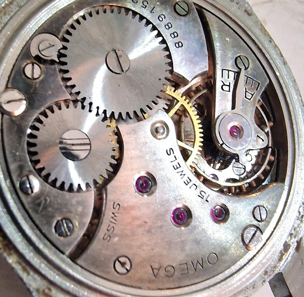 A vintage 1944 Omega wristwatch featuring a circular stainless steel case, black dial with Arabic numerals, sub-seconds dial, and a black leather strap. View V