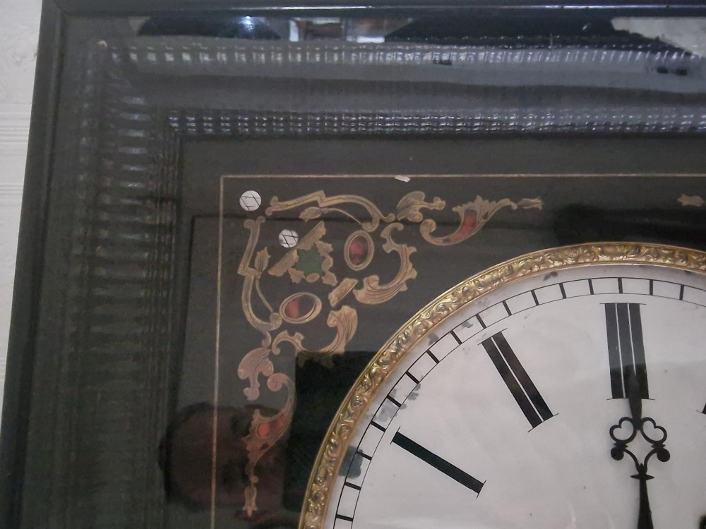 A square 19th-century French picture frame wall clock featuring an ebonised frame, an enamel dial signed Martin Baskett and Cie Paris, and brass and mother-of-pearl inlaid corner spandrels. View II