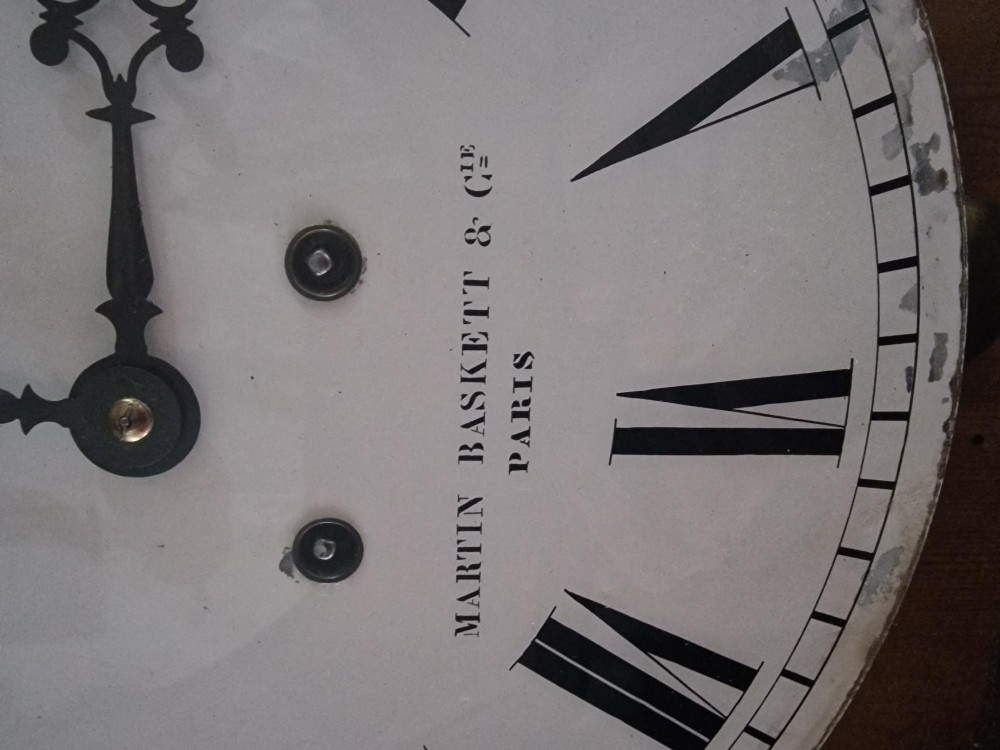 A square 19th-century French picture frame wall clock featuring an ebonised frame, an enamel dial signed Martin Baskett and Cie Paris, and brass and mother-of-pearl inlaid corner spandrels. View IV