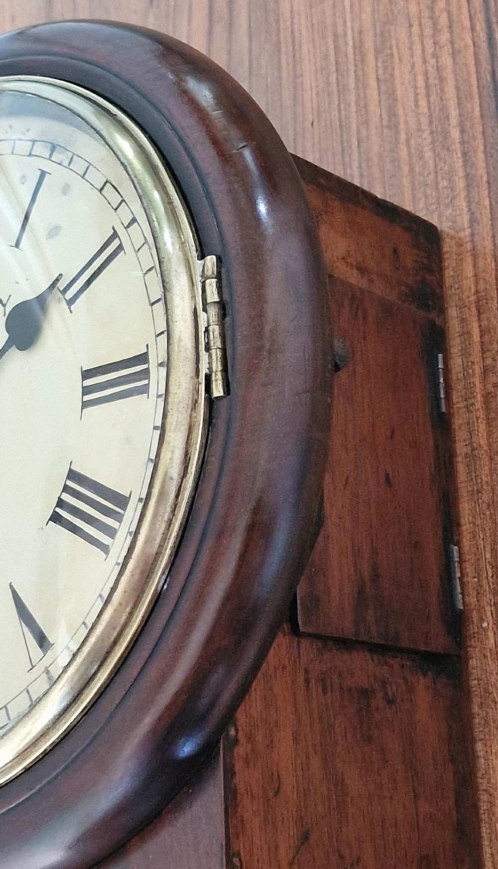 A small mahogany fusee wall clock featuring an eight-inch dial with Roman numerals, a brass bezel, and a lower wooden drop case. View VIII