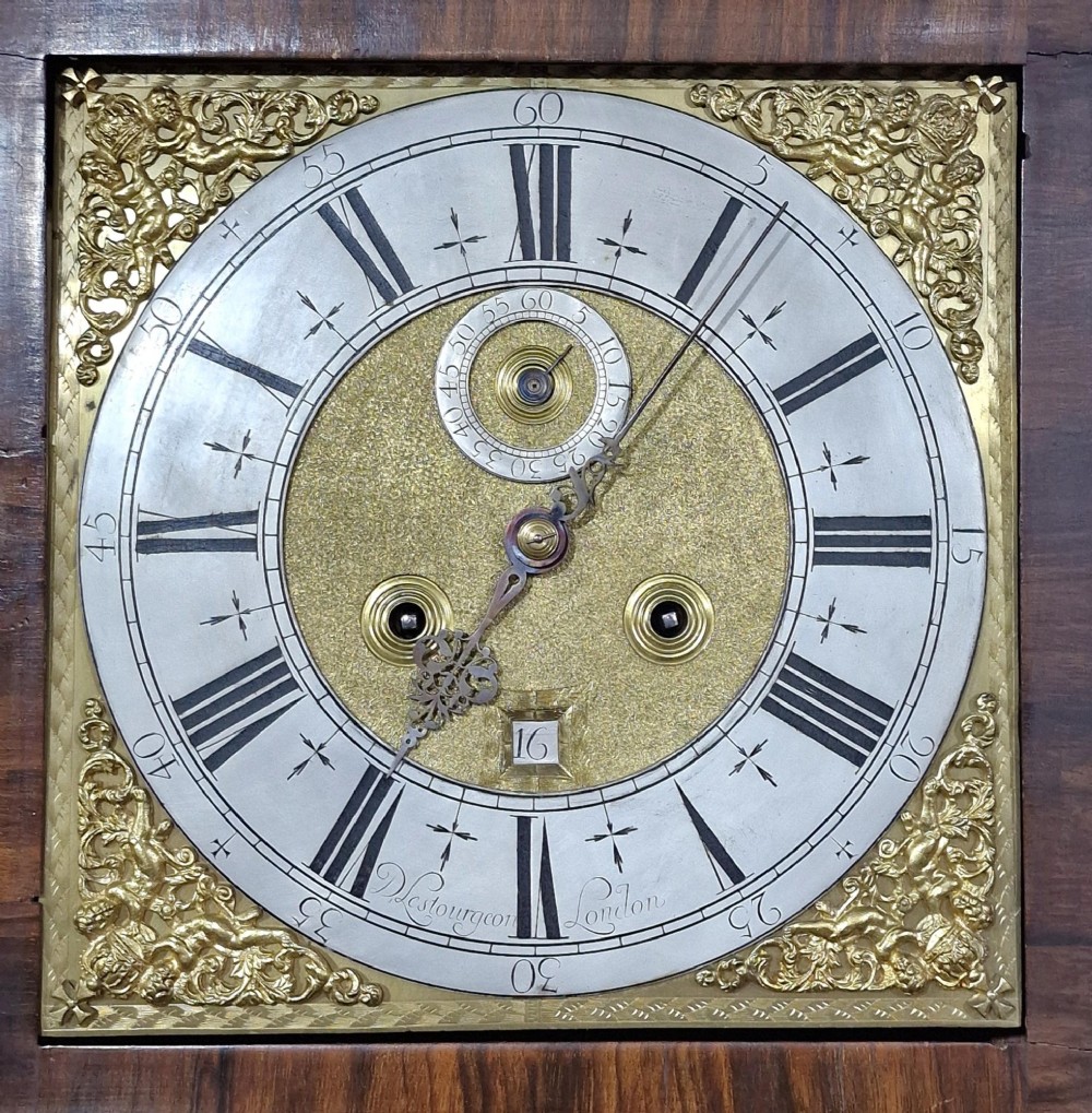 An English late 17th-century longcase clock with intricate floral marquetry veneer, a square brass dial, and a circular glass lenticle on the trunk door. View IV