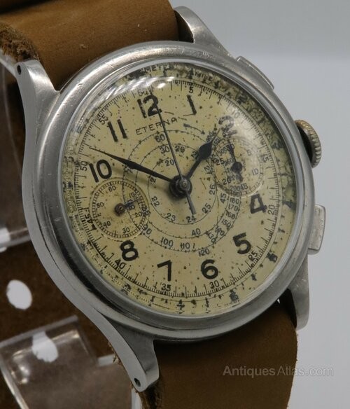 A vintage 1930s Eterna chronograph wristwatch with a patinated cream dial, two sub-dials, stainless steel case, and brown leather strap. View II