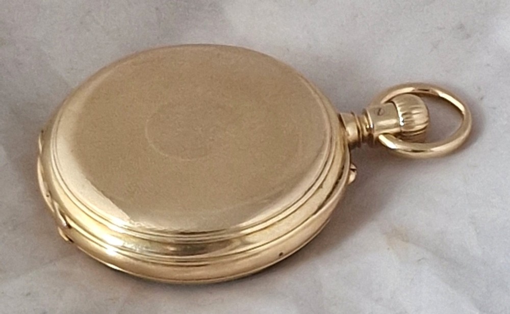 An open-face 18ct yellow gold pocket watch featuring a white enamel dial with black Roman numerals and a subsidiary seconds dial. View III