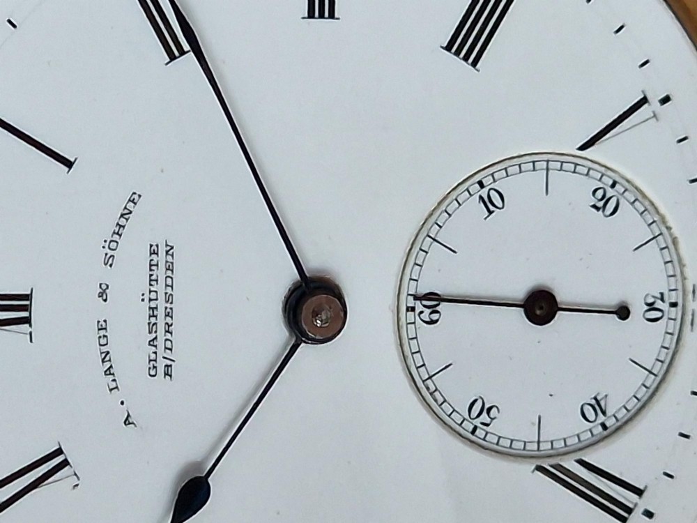 An open-face 18ct yellow gold pocket watch featuring a white enamel dial with black Roman numerals and a subsidiary seconds dial. View IV