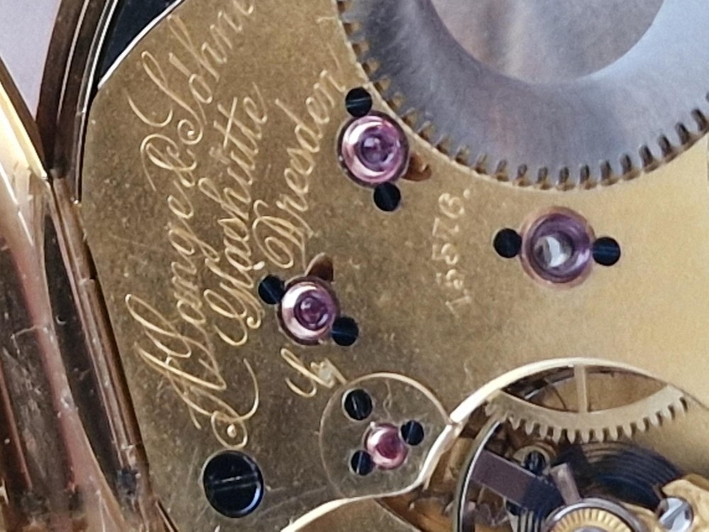 An open-face 18ct yellow gold pocket watch featuring a white enamel dial with black Roman numerals and a subsidiary seconds dial. View VI
