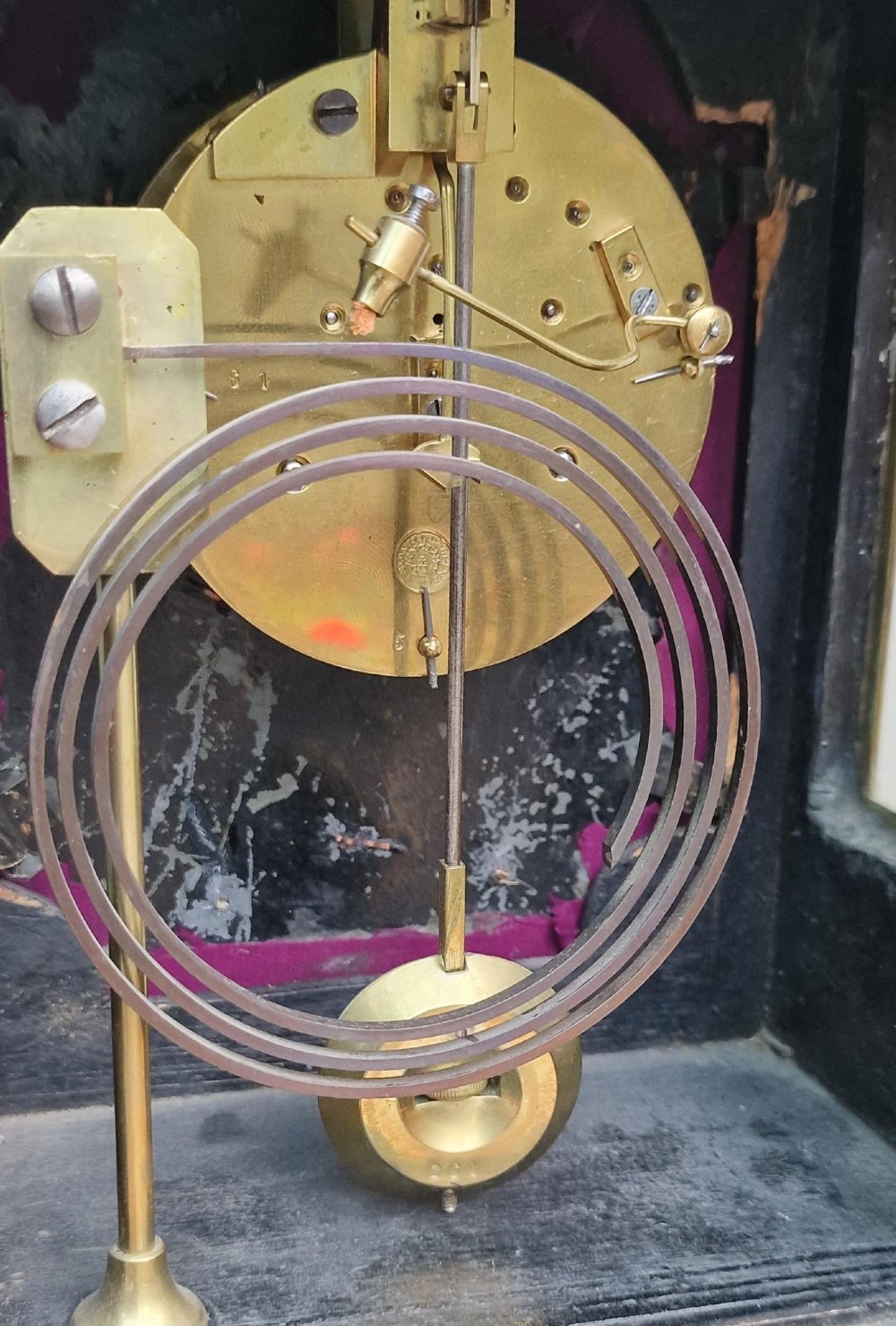A red tortoiseshell and gilt bronze mantel clock featuring enamel Roman numeral cartouches and cast finials. View VI