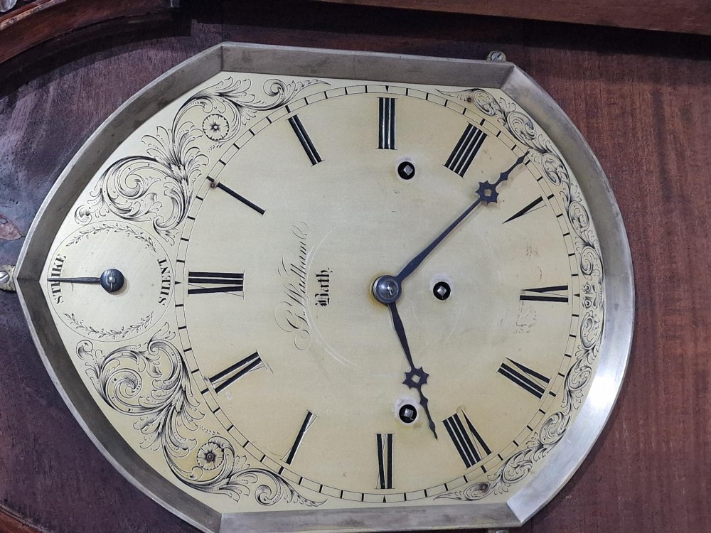 A carved oak Gothic Revival bracket clock featuring pointed arch cresting, turned finials, blind tracery details, and an engraved brass dial with Roman numerals. View IV