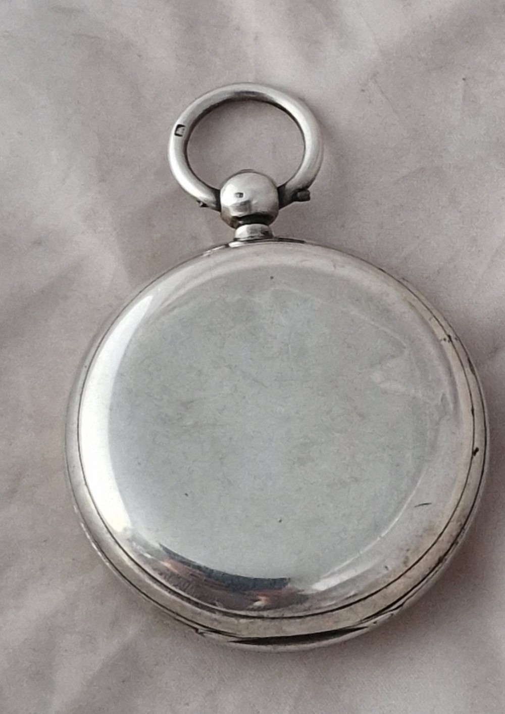 An antique silver open face fusee pocket watch featuring a white enamel dial with black Roman numerals, a subsidiary seconds dial, and an accompanying winding key. View II