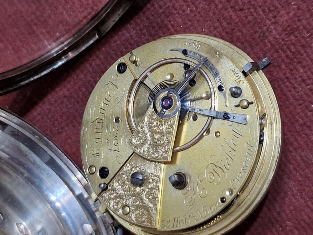 An antique silver open face fusee pocket watch featuring a white enamel dial with black Roman numerals, a subsidiary seconds dial, and an accompanying winding key. View IV