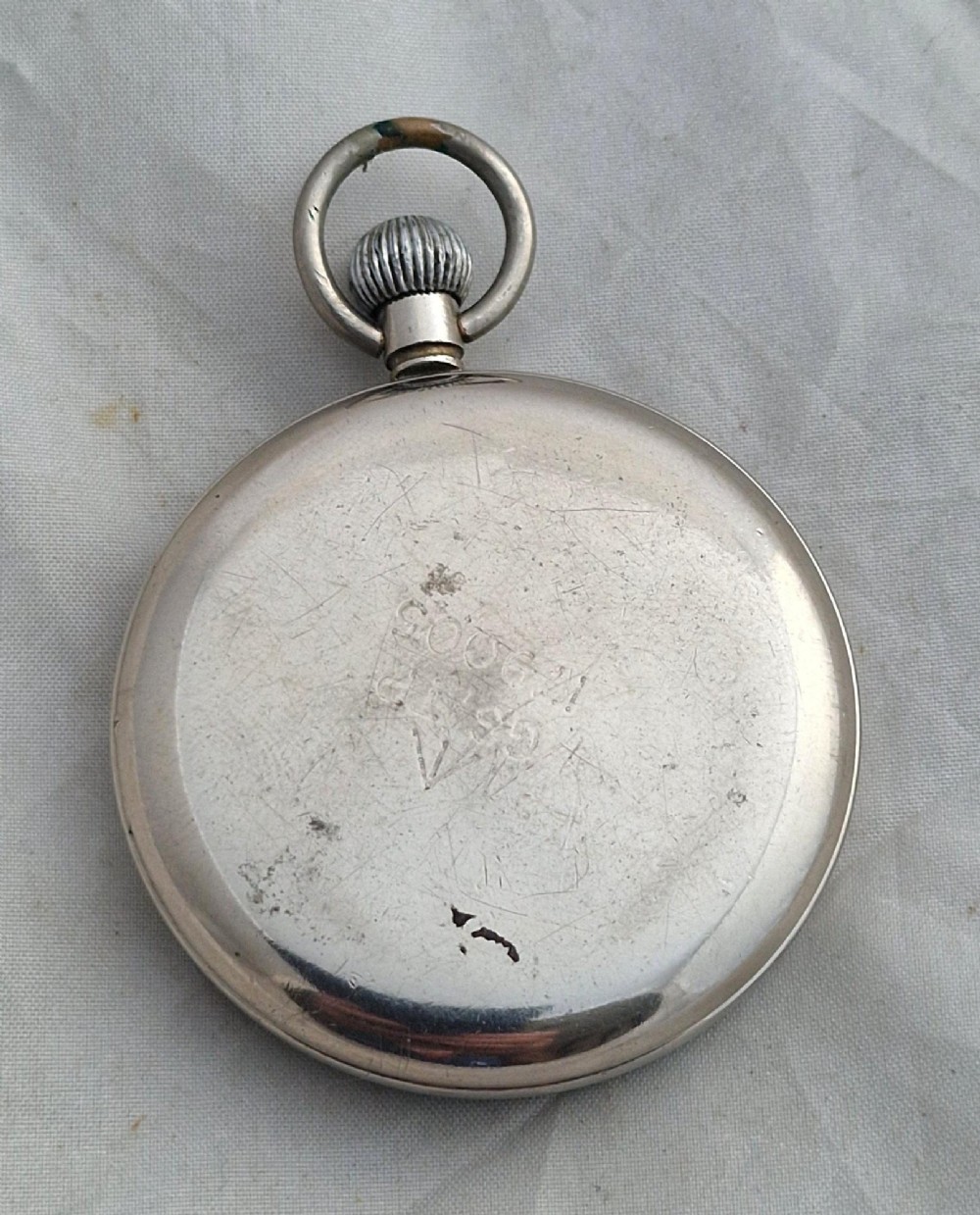 A Second World War Helvetia military pocket watch featuring a black dial with luminous Arabic numerals and a silver-toned metal case. View II