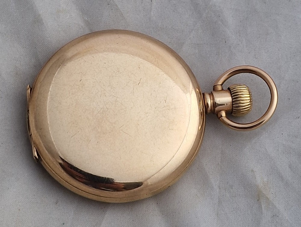 A gold full hunter pocket watch with an open outer case revealing a white enamel dial with black Roman numerals and a subsidiary seconds dial. View III