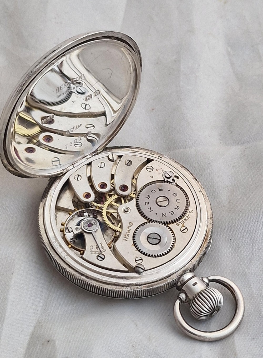 An open-face silver Buren pocket watch featuring a white enamel dial with Roman numerals and a small seconds sub-dial. View III