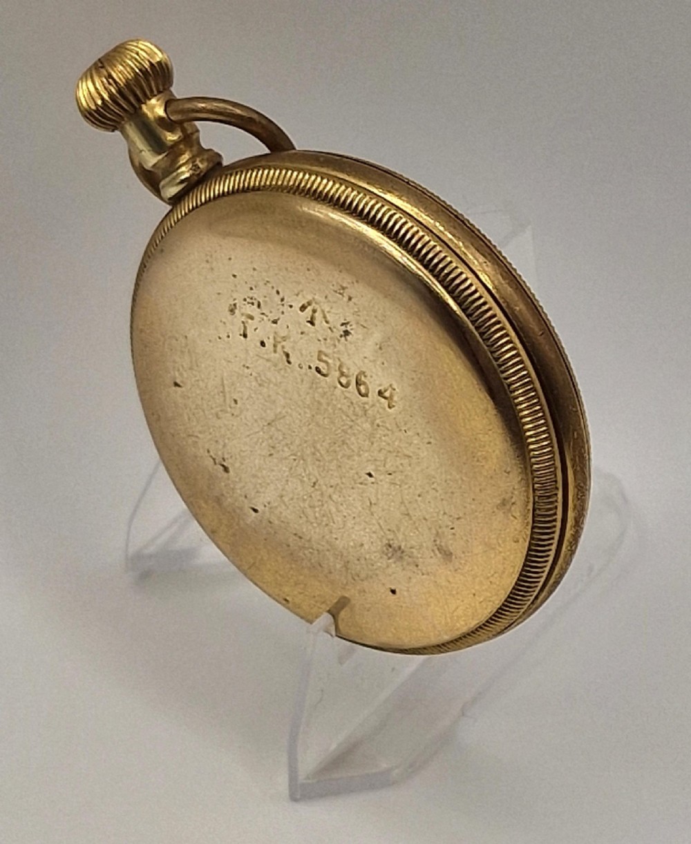 An open face Elgin pocket watch with a textured gold-coloured case, white enamel dial, black Roman numerals, steel hands, and a sub-seconds dial. View III