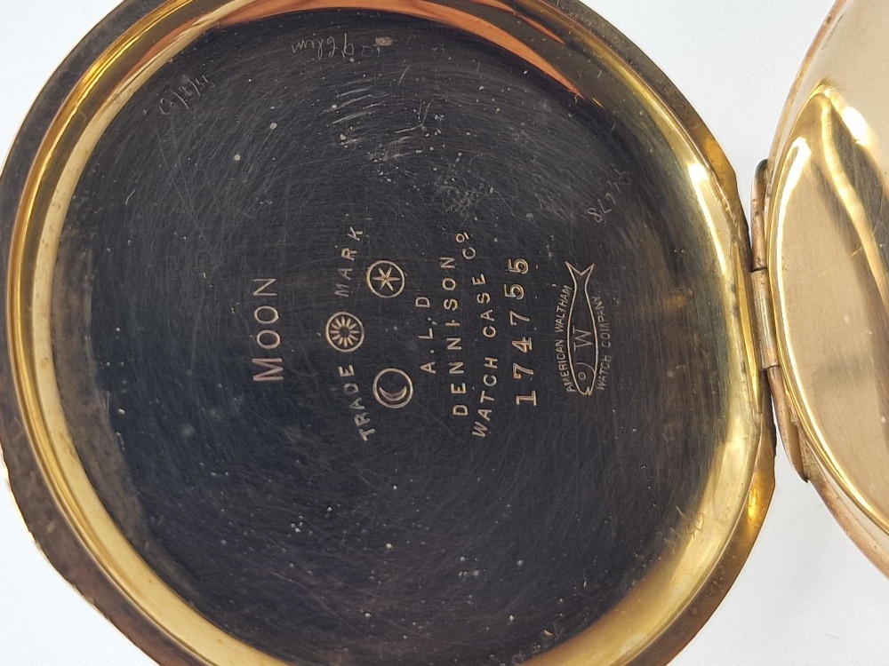 An open gold half hunter pocket watch displaying a white enamel dial with black Roman numerals and a small sub-seconds dial at six oclock. View IV