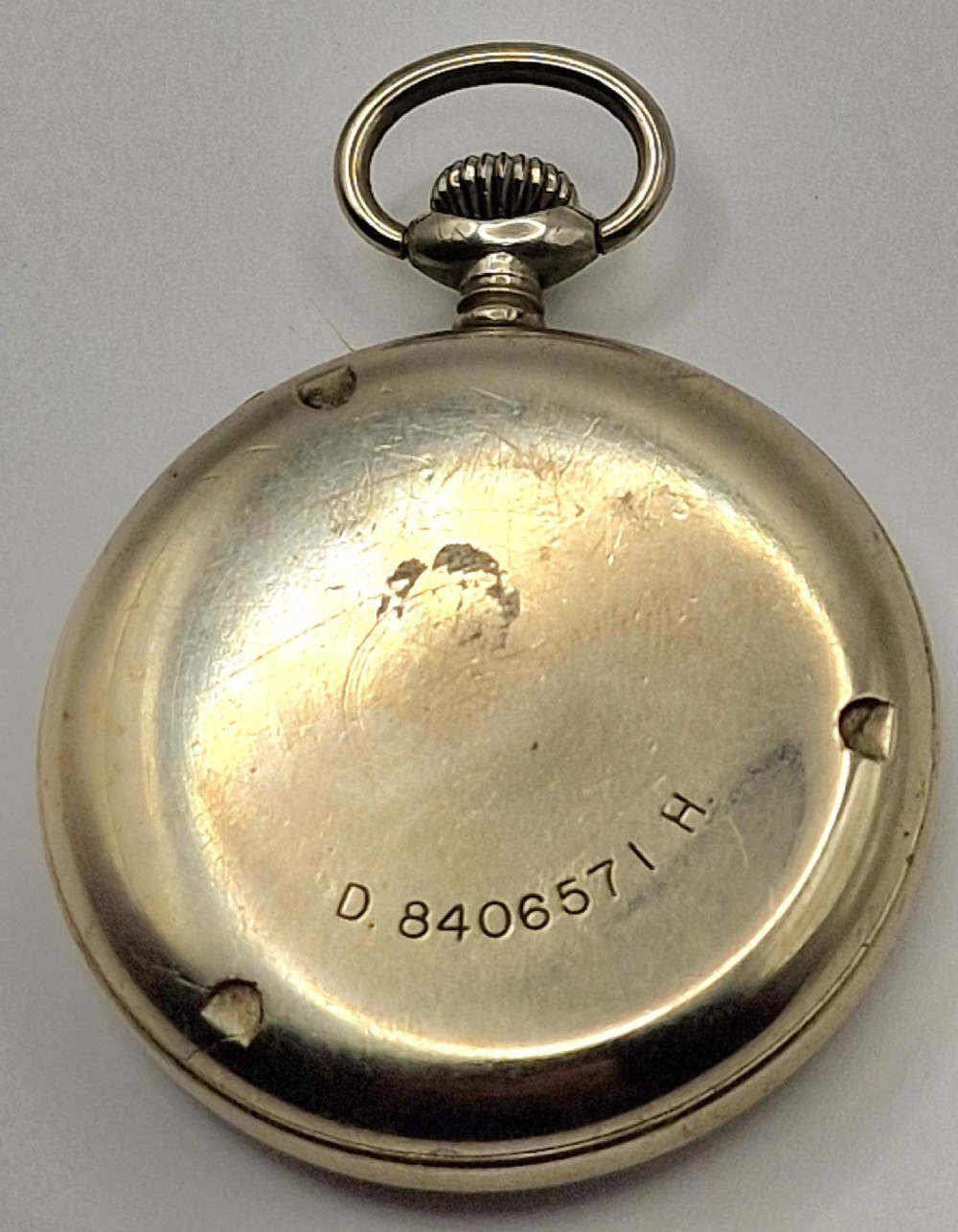 A Zenith open-face military pocket watch featuring a black dial, white Arabic numerals, a subsidiary seconds dial, and a silver-tone metal case. View III