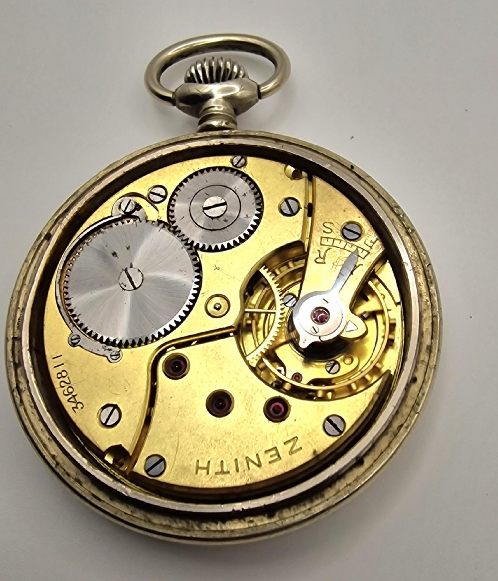 A Zenith open-face military pocket watch featuring a black dial, white Arabic numerals, a subsidiary seconds dial, and a silver-tone metal case. View IV