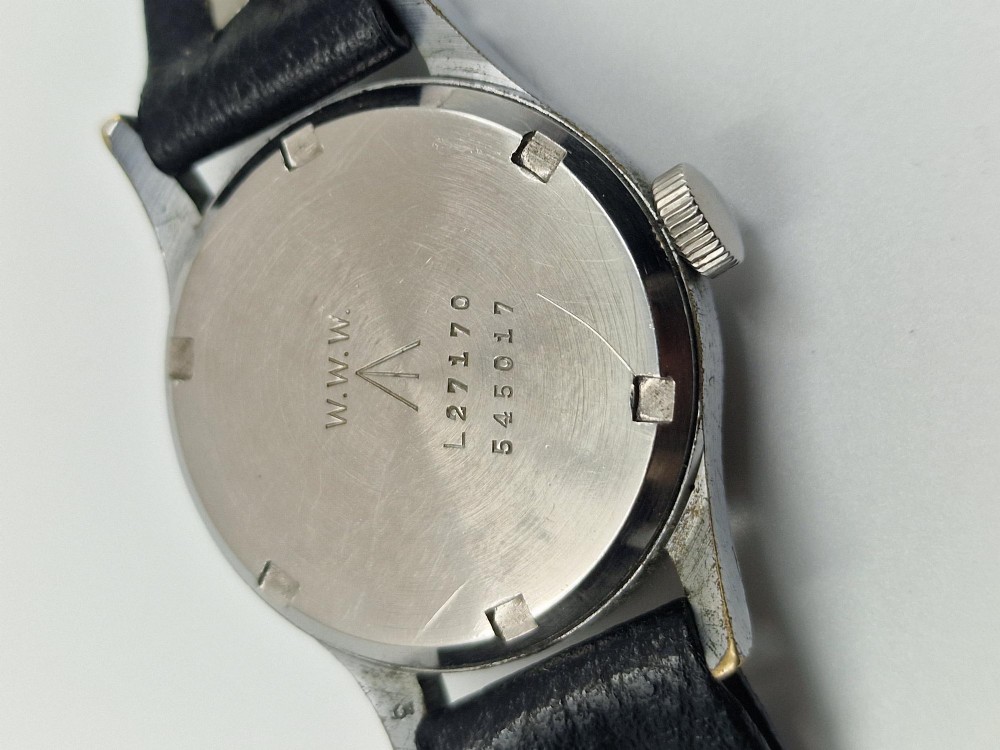 A 1940s Record military wristwatch featuring a black dial with luminous numerals, broad arrow mark, sub-seconds dial, and a black leather strap. View II