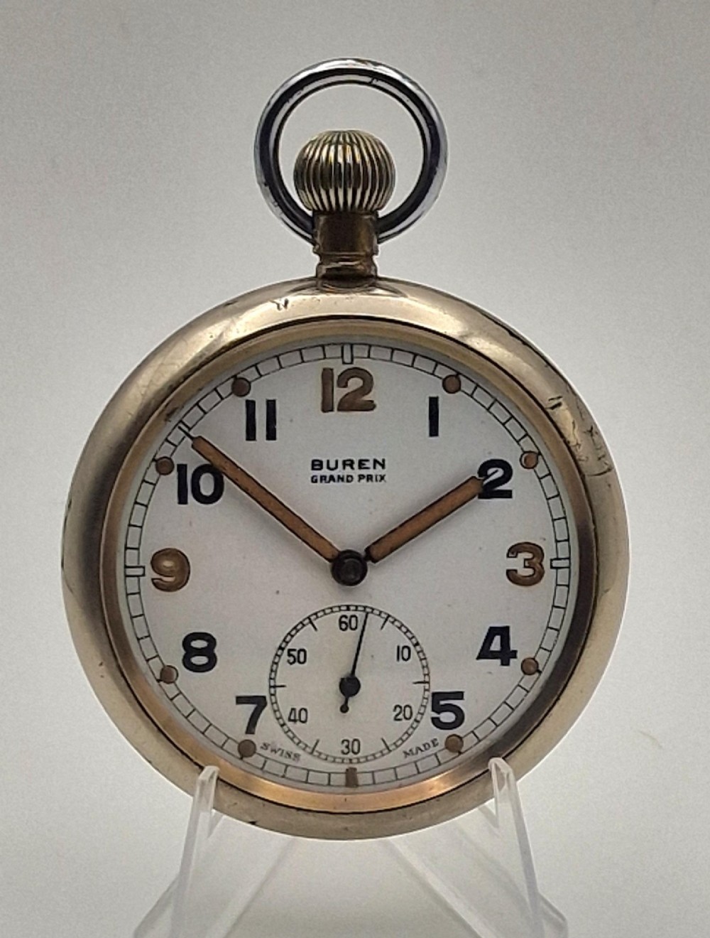 A vintage Buren Grand Prix Swiss pocket watch featuring a white dial, black Arabic numerals, luminous hands, a sub-seconds dial, and a silver-tone chrome case.