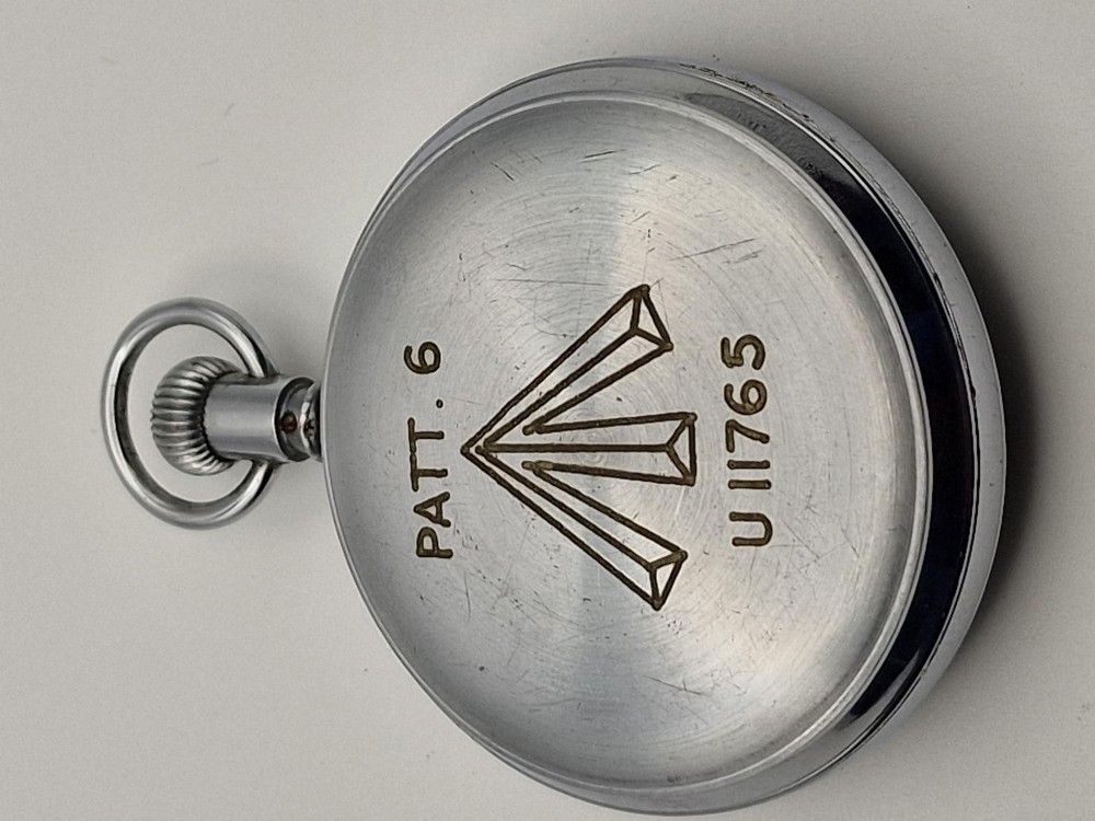 A circular vintage Waltham Admiralty Pattern No. 6 naval pocket timer featuring a chrome-plated metal casing and an aged cream dial with black and red markings. View II