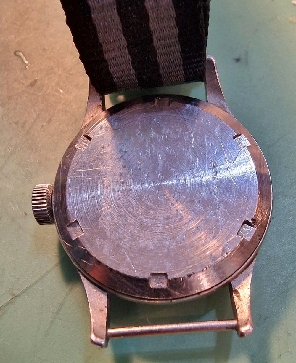 A vintage 1945 Omega military wristwatch featuring a stainless steel case, black dial with luminous Arabic numerals, sub-seconds dial, and a black and grey striped fabric strap. View II