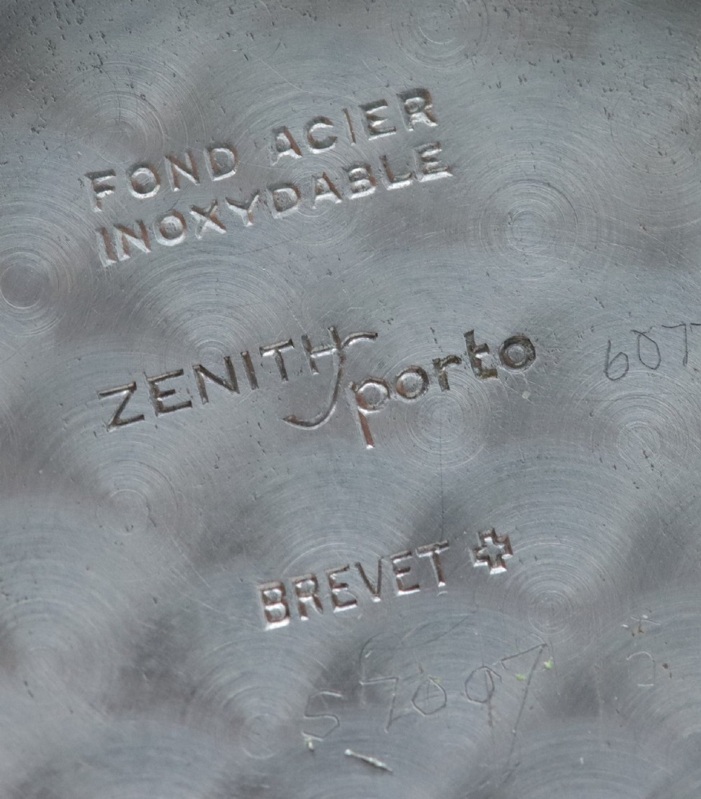 A 1950s Zenith Sporto mechanical wristwatch featuring a grey dial, Arabic numeral hour markers, a sub-seconds dial, and a brown leather strap. View VIII