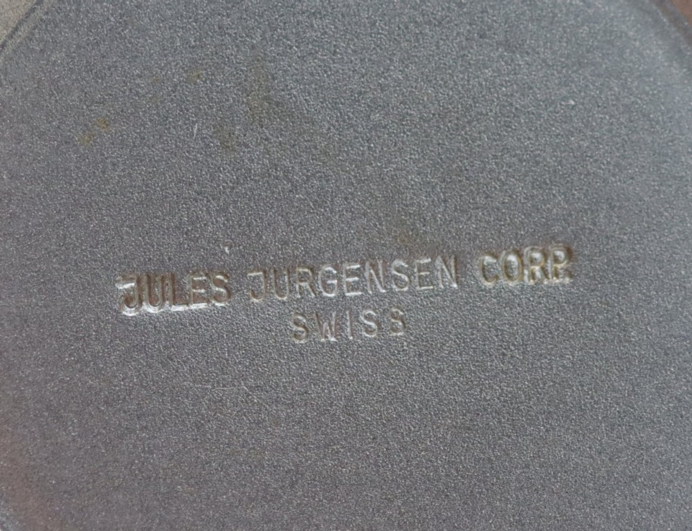 A 1970s Jules Jurgensen automatic wristwatch with a gold-toned circular cushion case, white dial, date aperture, and brown textured leather strap. View VIII