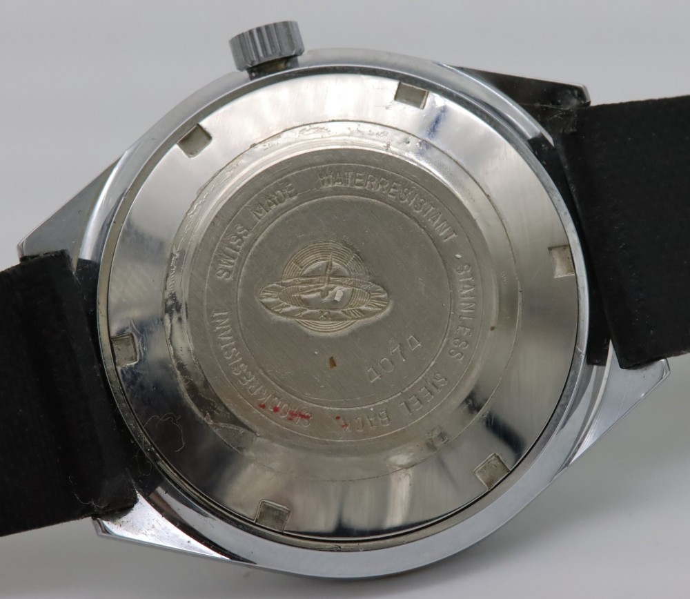 A 1970s Doxa automatic wristwatch featuring a cushion-shaped stainless steel case, blue dial with day-date aperture, and black strap. View VI
