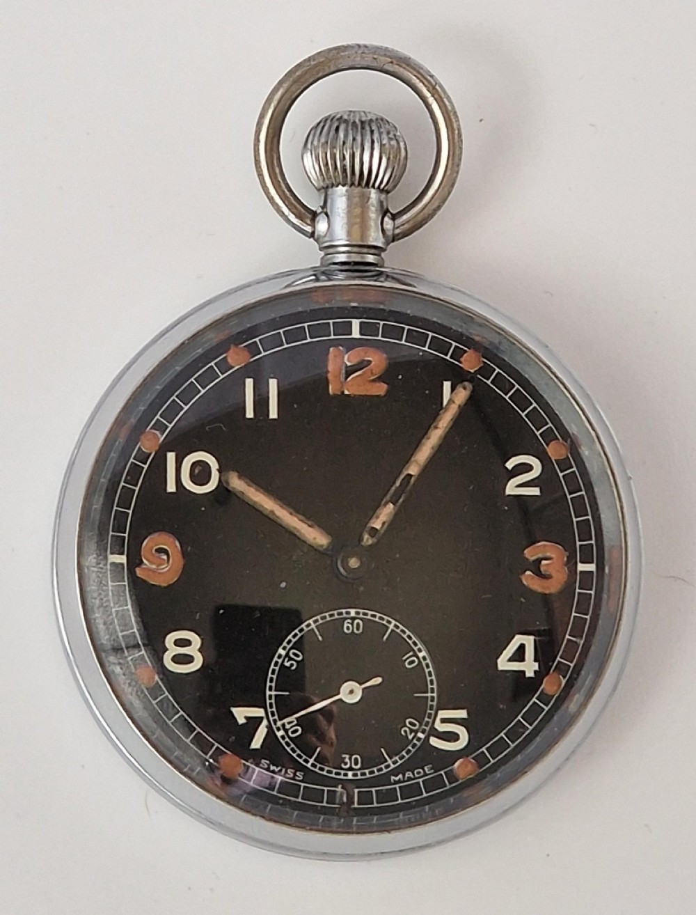 A vintage open-face military pocket watch featuring a silver-coloured metal casing, black dial with luminous Arabic numerals, and a sub-seconds dial at six oclock. View II