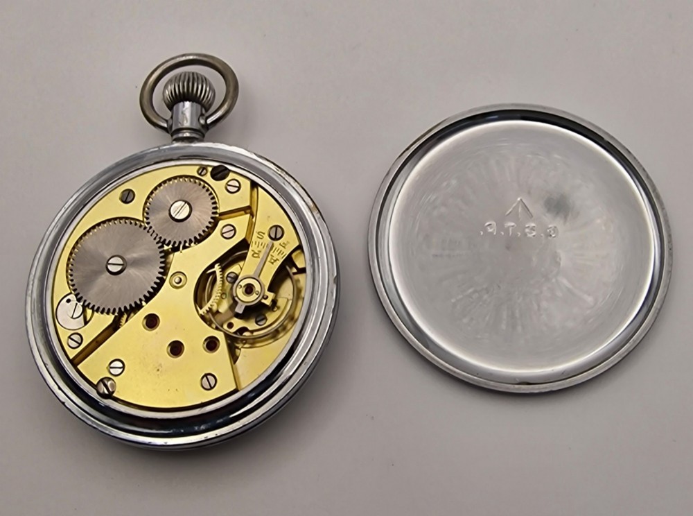 A vintage open-face military pocket watch featuring a silver-coloured metal casing, black dial with luminous Arabic numerals, and a sub-seconds dial at six oclock. View IV