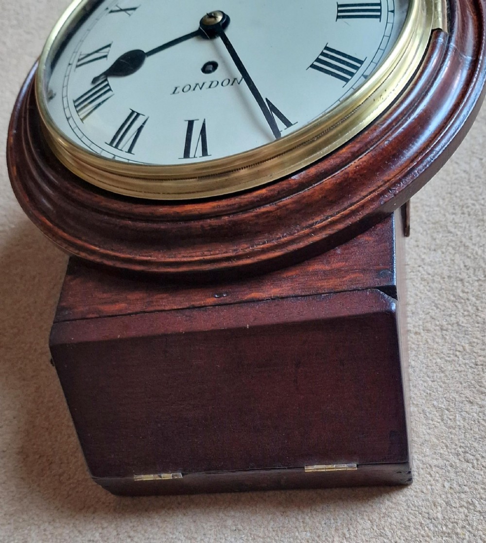 An antique wall clock featuring a circular white dial marked Short London with Roman numerals, housed in a moulded mahogany wooden casing with a brass-framed glass bezel. View II