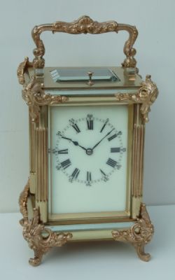 A FRENCH ROCOCO MOUNTED STRIKEREPEATING CARRIAGE CLOCK