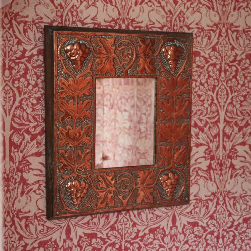 an arts and crafts copper repouss wall mirror - CATEGORY: ANTIQUE MIRRORS - DATED 1900