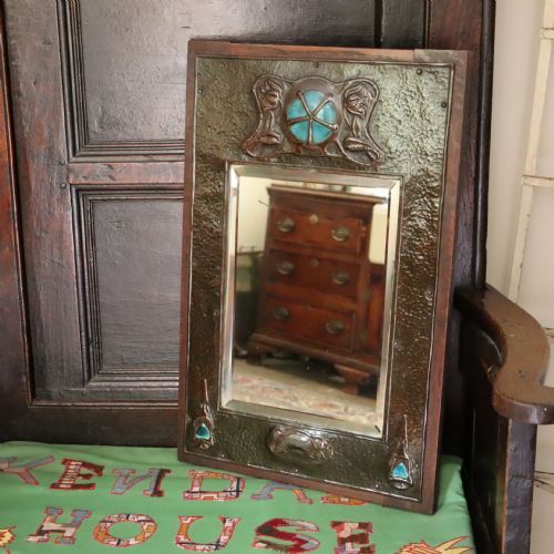 AN ARTS AND CRAFTS REPOUSS AND OAK FRAMED MIRROR - ADDITIONAL PHOTO 1